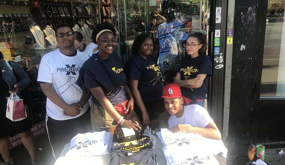 Students selling the apparel brand they created at a pop-up shop